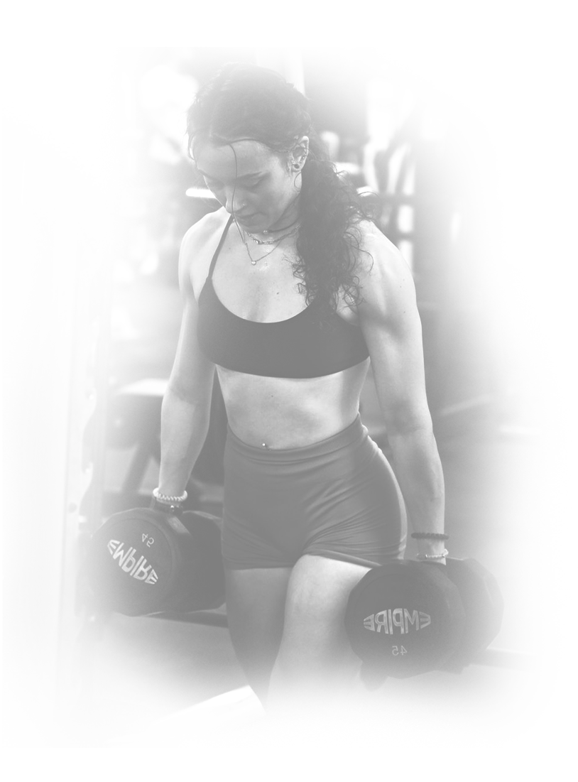 a woman lifting dumbbells in the gym