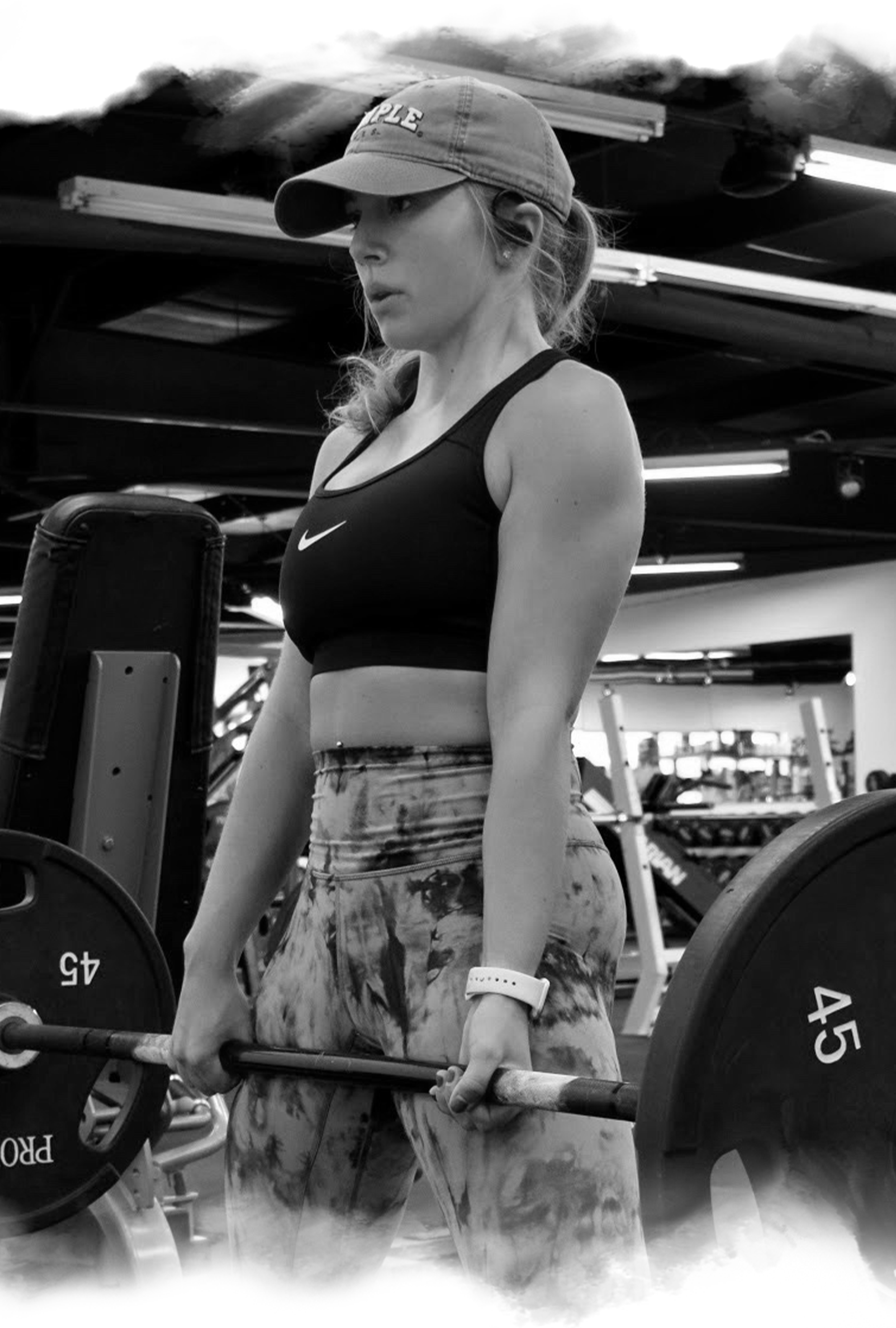 a woman lifting barbell in the gym