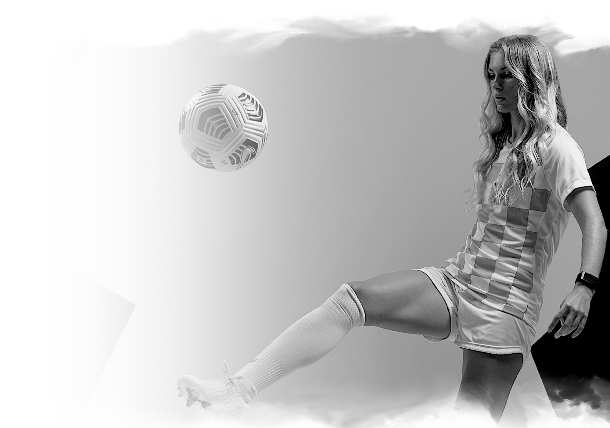 a woman dribbling on a soccer ball